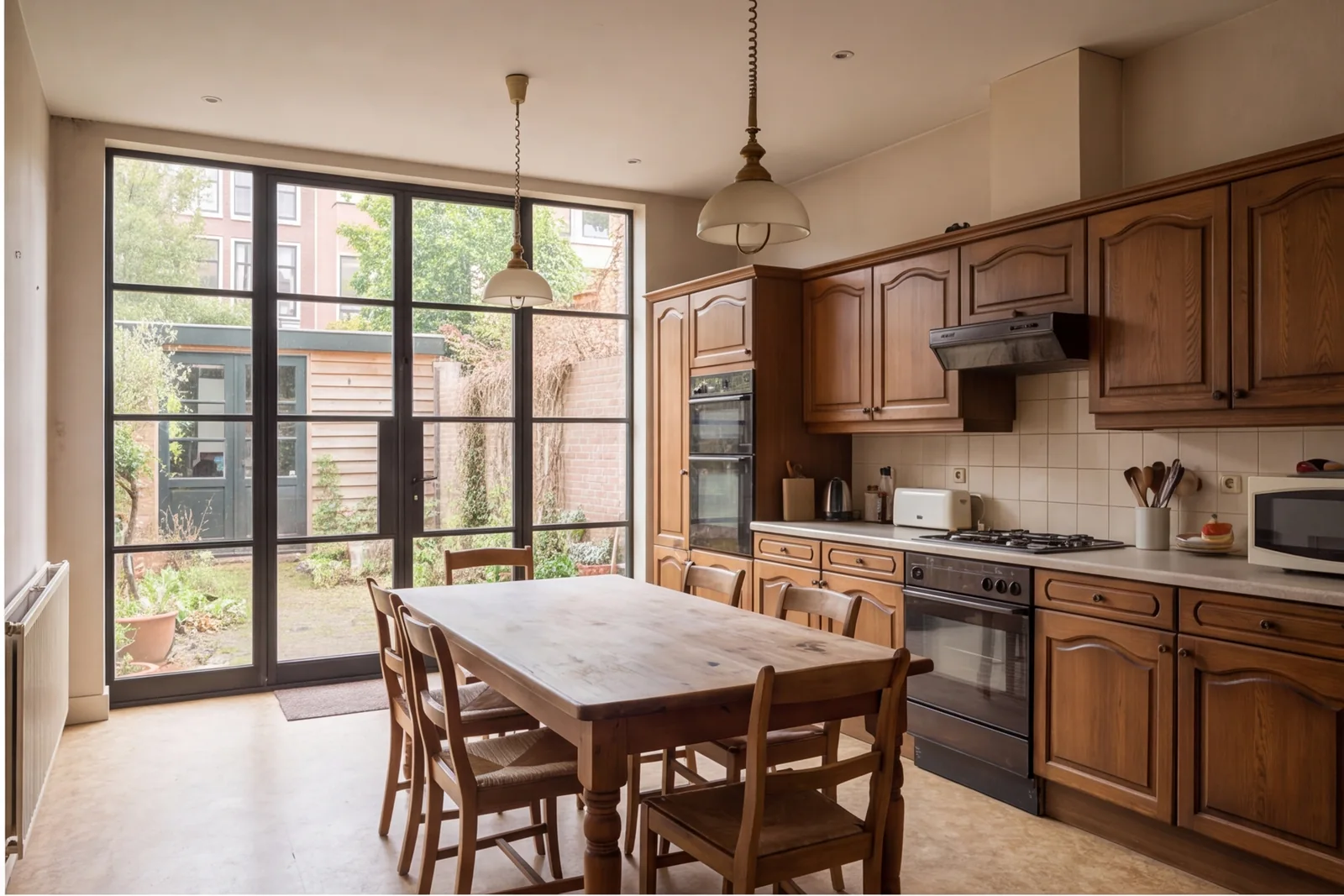 Before concept: Kitchen with rear black-framed doors and long oak island