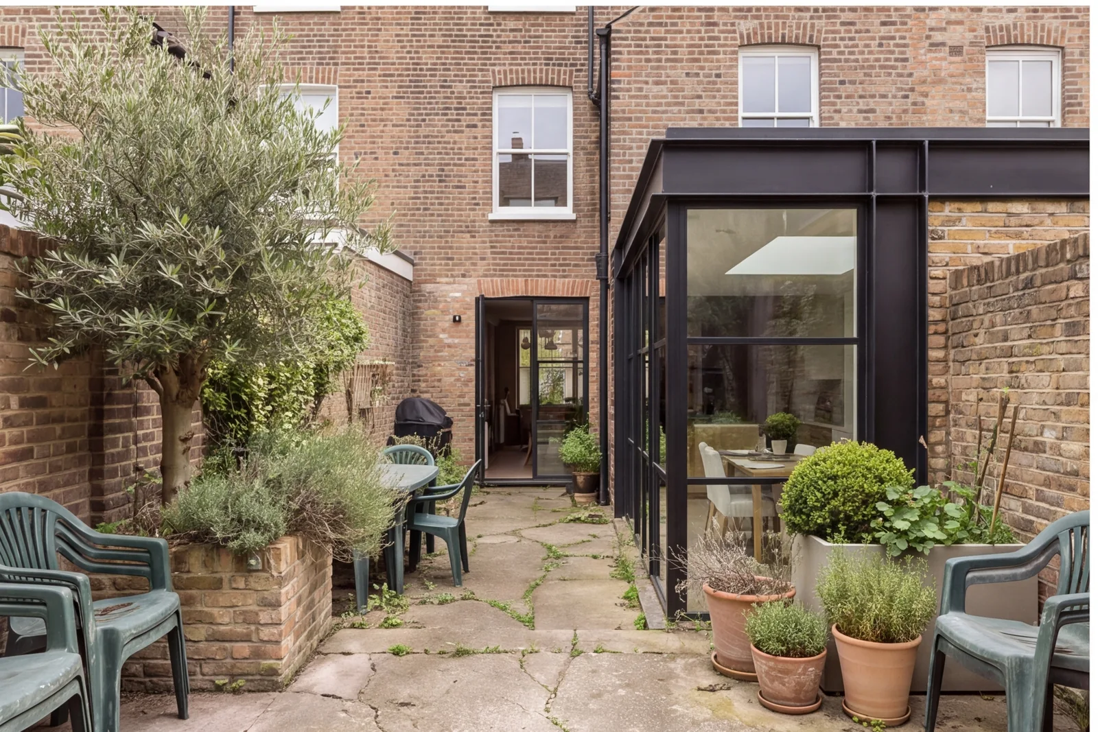 Before concept: Courtyard terrace looking at brick house
